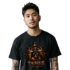 Male model with arm tattoos wearing a premium black graphic streetwear t-shirt featuring a detailed Taurus crown and charging bull design by Essentia Collective.