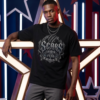 male model wearing a black premium Essentia Collective graphic t-shirt with a metallic gothic chest graphic reading Scars Louder Than Fear, leaning against large illuminated neon star structures.
