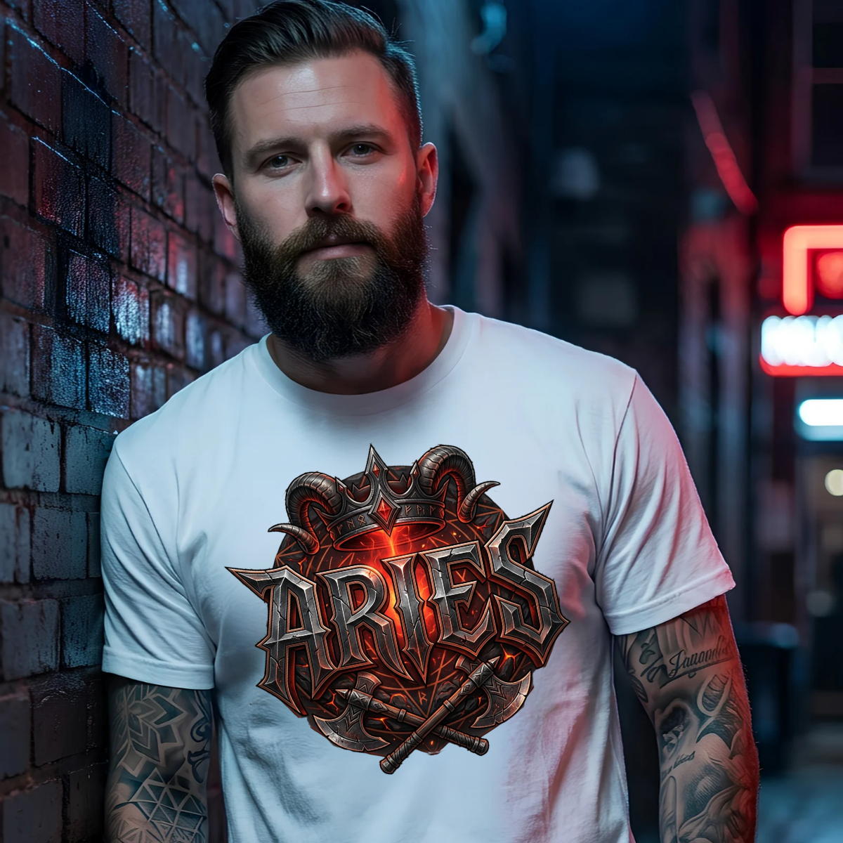 Bearded male model with tattoos leaning against a brick wall wearing a premium white graphic streetwear t-shirt featuring a detailed Aries crown and crossed axes design by Essentia Collective.