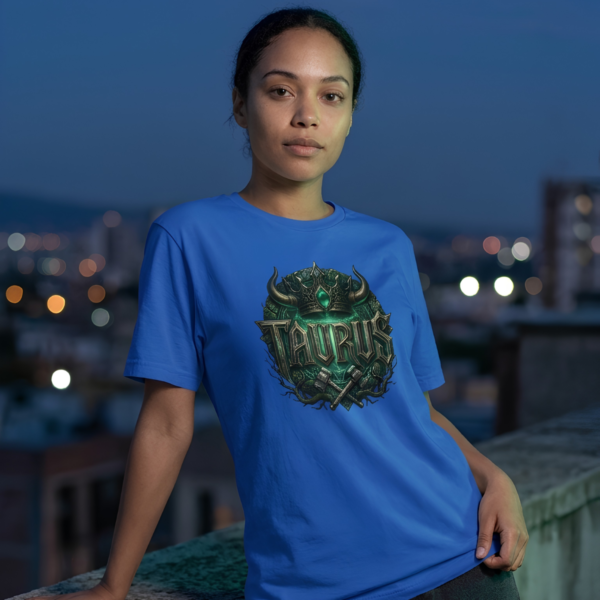 Female model leaning against a rooftop ledge wearing a premium blue graphic streetwear t-shirt featuring a detailed Taurus horned crown and hammers design by Essentia Collective.