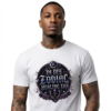 Studio portrait mockup of a tattooed male model on a clean white background, wearing a white graphic streetwear t-shirt with a prominent black, violet, and silver gothic astrological crest reading In My Zodiac Healing Era.
