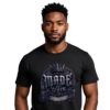 Made Not Given Gothic Style Black Streetwear T-shirt male model with a sharp beard on a clean white background, wearing a premium heavyweight black streetwear t-shirt with a detailed silver and blue metallic gothic chest graphic reading Made Not Given.