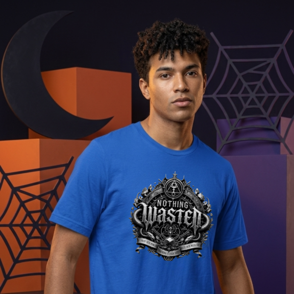 Nothing Wasted Streetwear T-Shirt Royal Blue male model with curly hair standing in front of orange abstract geometric blocks, a black crescent moon, and a purple spiderweb backdrop, wearing a vibrant blue Essentia Collective graphic streetwear t-shirt with a detailed silver gothic emblem reading Nothing Wasted.