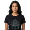 Female model wearing a black Essentia Collective t-shirt featuring a detailed silver gothic emblem with the text Restart Reset Refocus and alchemical symbols.
