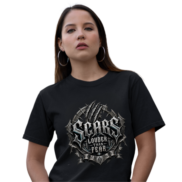 Studio product mockup of a female model with dark hair and hoop earrings, wearing a black premium Essentia Collective graphic t-shirt featuring a silver gothic emblem with claw marks reading Scars Louder Than Fear.