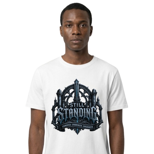 Studio portrait mockup of a male model on a clean white background, wearing a premium white Essentia Collective graphic streetwear t-shirt with a detailed silver and ice-blue gothic cathedral emblem reading Still Standing.