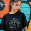 Female model with her hair in a high ponytail standing in front of a colorful graffiti brick wall, wearing a premium black graphic streetwear t-shirt featuring a detailed Virgo armored archetype design by Essentia Collective.