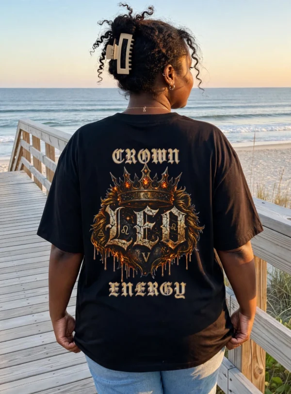 Model wearing Leo Crown Energy black gothic streetwear T-shirt on beach boardwalk