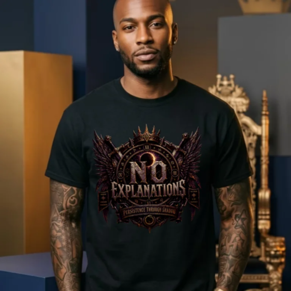 Tattooed male model standing in a dark alternative studio in front of a golden throne, wearing a premium black Essentia Collective graphic streetwear t-shirt with a copper and gold gothic emblem that reads No Explanations.