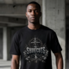 male model standing in an open raw concrete parking garage structures wearing a black premium Essentia Collective graphic streetwear t-shirt with a detailed silver gothic compass emblem reading No Shortcuts.