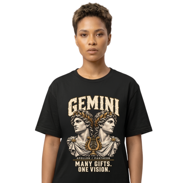 Female model wearing a black Gemini zodiac graphic T-shirt featuring gold-toned Apollon-inspired mythology artwork.