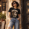Woman wearing a black Sagittarius zodiac graphic T-shirt and denim shorts in a vintage urban interior.