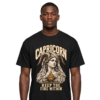Male model wearing a black Capricorn zodiac graphic T-shirt featuring gold-toned Hestia-inspired artwork.