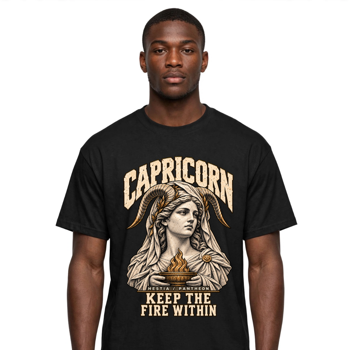 Male model wearing a black Capricorn zodiac graphic T-shirt featuring gold-toned Hestia-inspired artwork.